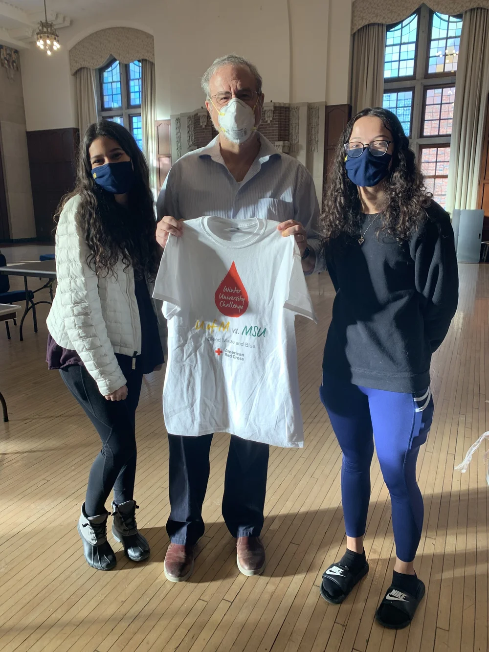 Students presenting a Winter University Challenge shirt
