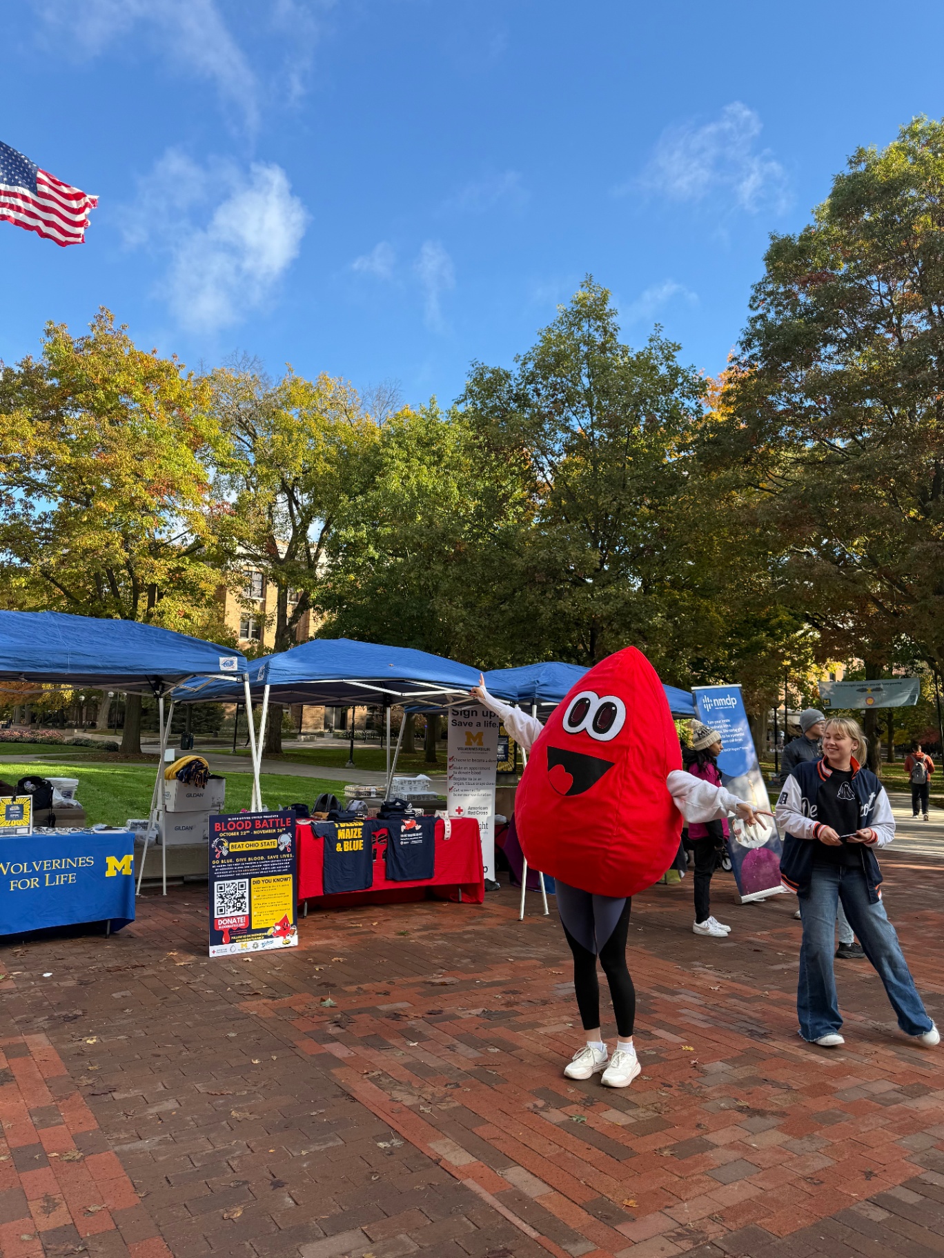 Blood Drives United mascot and volunteers tabling on the Diag
