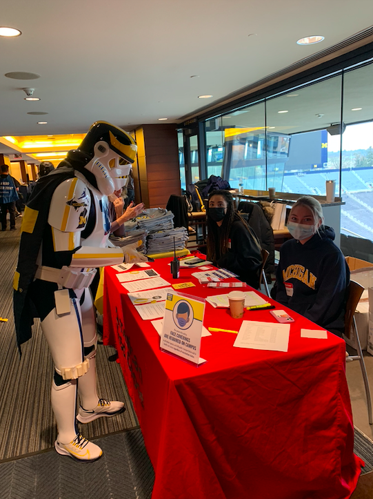 Volunteers staffing a donor check-in table at Michigan Stadium