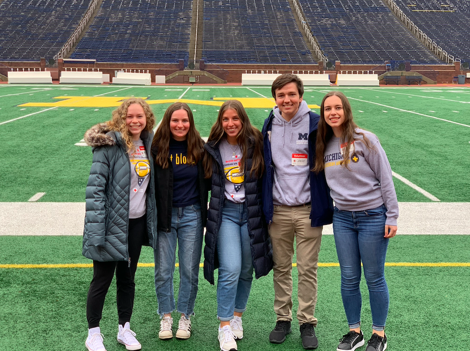 BDU volunteers together on the field at Michigan Stadium